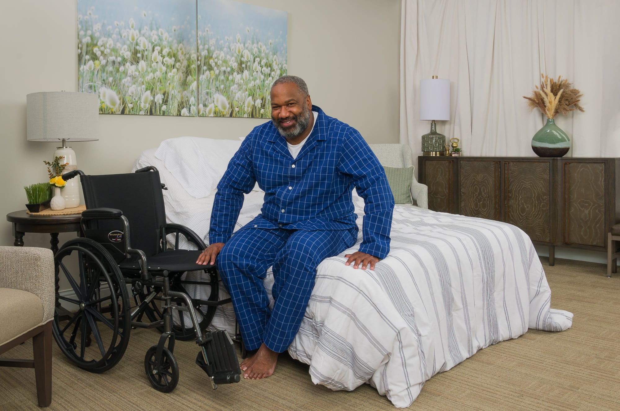Supernal 5 in use, sitting on bed, ready to get in wheelchair