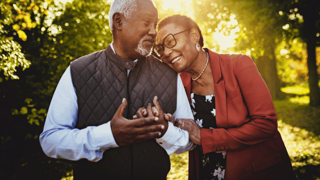Older couple smiling and walking outdoors — showing health, energy, and independence gained through better sleep and supportive bedding