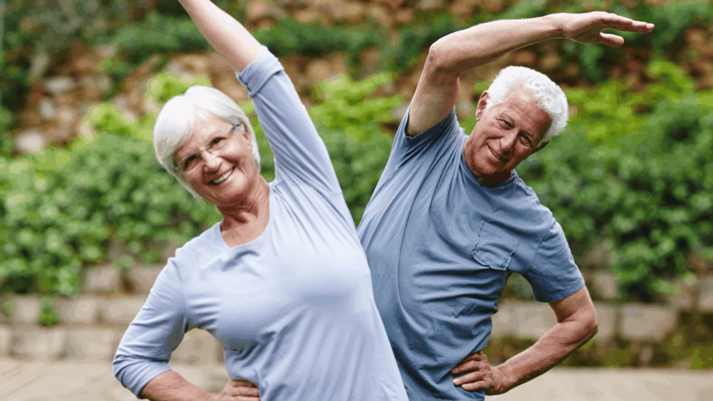 Older couple performing gentle side stretches outdoors, promoting flexibility, balance, and active aging supported by Transfer Master® independence aids.